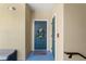 Charming condo entrance with a welcoming teal door, a cheerful wreath, and a 'hello' doormat inviting visitors inside at 438 Water St # 438, Celebration, FL 34747