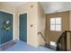 Hallway with stairway access to units; entry door has wreath and welcome mat at 438 Water St # 438, Celebration, FL 34747