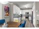 Bright kitchen features white cabinets, stainless steel appliances, granite counters, and unique backsplash design at 438 Water St # 438, Celebration, FL 34747