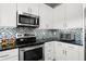 Bright and modern kitchen featuring stainless steel appliances and white cabinetry at 438 Water St # 438, Celebration, FL 34747