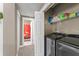 Functional laundry room with washer and dryer, shelving, and closet space for storage at 438 Water St # 438, Celebration, FL 34747