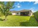 The backyard is covered in grass and has a covered patio at 5009 E Fountainwood Dr, St Cloud, FL 34772