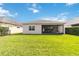 The backyard is covered in grass and has a covered patio at 5009 E Fountainwood Dr, St Cloud, FL 34772