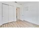 Bright bedroom with wood floors, closet, and natural light streaming through the window at 5009 E Fountainwood Dr, St Cloud, FL 34772