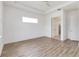 A bright bedroom with wood-look floors, a ceiling fan, and one window at 5009 E Fountainwood Dr, St Cloud, FL 34772