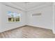Bright bedroom features wood-look floors, a ceiling fan, and two windows at 5009 E Fountainwood Dr, St Cloud, FL 34772