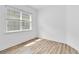 Sunlit bedroom with natural light, and wood-look floors; window with blinds at 5009 E Fountainwood Dr, St Cloud, FL 34772