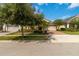 Charming single-story home with a well-manicured lawn and a brick-paved driveway and mature landscaping at 5009 E Fountainwood Dr, St Cloud, FL 34772