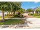 Charming single-story home with a well-manicured lawn and a brick-paved driveway and mature landscaping at 5009 E Fountainwood Dr, St Cloud, FL 34772