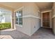 Inviting front porch with brick pavers leading to the front door and a large window at 5009 E Fountainwood Dr, St Cloud, FL 34772