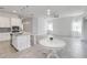 Open floor plan with a white kitchen, island, granite counters, and an adjacent dining area at 5009 E Fountainwood Dr, St Cloud, FL 34772
