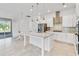Modern kitchen featuring stainless steel appliances, granite counters, island, and sliding doors to the patio at 5009 E Fountainwood Dr, St Cloud, FL 34772