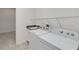 Bright laundry room equipped with modern white appliances and a utility sink for added convenience at 5009 E Fountainwood Dr, St Cloud, FL 34772