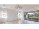 Bright living room with tile floors, ceiling fan, and sliding glass doors to the patio at 5009 E Fountainwood Dr, St Cloud, FL 34772