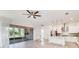 Bright open living space with tile floors, white cabinets, modern appliances, and view to screened porch at 5009 E Fountainwood Dr, St Cloud, FL 34772