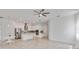 Bright open living space with tile floors, white cabinets, modern appliances, and modern lighting at 5009 E Fountainwood Dr, St Cloud, FL 34772
