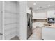 Walk-in pantry with wire shelving and a view into the kitchen at 5009 E Fountainwood Dr, St Cloud, FL 34772