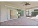 A covered patio with brick flooring and a fan offers views of the green backyard at 5009 E Fountainwood Dr, St Cloud, FL 34772