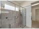 Modern glass shower with gray tile and a built-in shower seat at 5009 E Fountainwood Dr, St Cloud, FL 34772