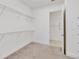 Spacious walk-in closet with carpet flooring and wire shelving for ample storage, plus an adjoining room at 5009 E Fountainwood Dr, St Cloud, FL 34772