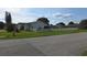 View of single story home and white picket fence with neatly manicured front lawn at 501 Kilimanjaro Dr, Kissimmee, FL 34758