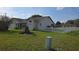 Home exterior showing a green lawn, manicured shrubs and a white picket fence at 501 Kilimanjaro Dr, Kissimmee, FL 34758