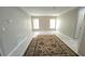 Living room features tile flooring, neutral walls, and a large rug in the center at 501 Kilimanjaro Dr, Kissimmee, FL 34758