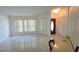 Open living room featuring tile flooring, large windows and a wooden front door at 501 Kilimanjaro Dr, Kissimmee, FL 34758