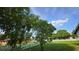 Large lawn with mature landscaping and a white picket fence at 501 Kilimanjaro Dr, Kissimmee, FL 34758
