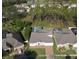 Aerial view showcases the home's enclosed pool and lush surroundings in a serene community at 518 Brighton Dr, Davenport, FL 33897
