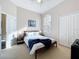 This is a bedroom with carpet, a ceiling fan, a double bed, two night tables and lamps and artwork on the walls at 518 Brighton Dr, Davenport, FL 33897