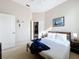 This is a bedroom with carpet, a ceiling fan, a double bed, one night table and lamp and artwork on the walls at 518 Brighton Dr, Davenport, FL 33897
