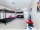 This extra room with carpeted floors is furnished with two sets of bunk beds and an additional futon for extra sleeping at 518 Brighton Dr, Davenport, FL 33897