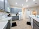 Well-lit kitchen featuring gray cabinets, modern appliances, and ample counter space for food preparation at 518 Brighton Dr, Davenport, FL 33897