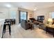 Relaxing living room with ample seating, neutral décor, and seamless flow to the adjacent dining area at 518 Brighton Dr, Davenport, FL 33897
