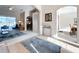 Open-concept living room showcasing arched doorways and neutral color palette with plush carpet at 518 Brighton Dr, Davenport, FL 33897