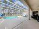 A screened-in pool area featuring lounge chairs and a covered patio for relaxation at 518 Brighton Dr, Davenport, FL 33897