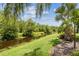 Lush backyard featuring tranquil waterway views at 608 Grand Canal Dr, Poinciana, FL 34759