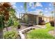Beautiful backyard with a screened-in lanai and lush landscaping at 608 Grand Canal Dr, Poinciana, FL 34759