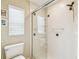 Bathroom featuring a glass shower with white tiling, a bright window, and modern sink fixtures at 608 Grand Canal Dr, Poinciana, FL 34759
