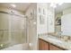 Well-lit bathroom with a shower and tub combo, granite countertop, and decorative wall art at 608 Grand Canal Dr, Poinciana, FL 34759