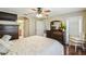 Comfortable main bedroom with modern furnishings, wood floors, and neutral paint at 608 Grand Canal Dr, Poinciana, FL 34759