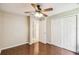 Spacious bedroom features wood floors, ceiling fan, closet, and an entryway providing access to other parts of the home at 608 Grand Canal Dr, Poinciana, FL 34759