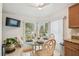 Bright breakfast nook with bay window, glass table, and seating for four at 608 Grand Canal Dr, Poinciana, FL 34759