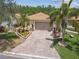 Well-maintained home with a paved driveway and manicured landscaping at 608 Grand Canal Dr, Poinciana, FL 34759