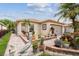 Home featuring beautiful landscaping with a variety of plants, flowers, and brick-lined garden beds at 608 Grand Canal Dr, Poinciana, FL 34759