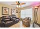Inviting living room boasts a comfortable leather sofa, patterned armchair, and stylish decor for relaxing and entertaining at 608 Grand Canal Dr, Poinciana, FL 34759