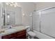 Bathroom featuring granite countertop, wood cabinet, and a shower/tub combo at 7013 Beargrass Rd, Harmony, FL 34773