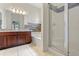 Bright bathroom featuring a glass-enclosed shower and a soaking tub with stone backsplash at 7013 Beargrass Rd, Harmony, FL 34773