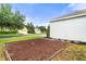 Well-maintained house exterior with side yard and mature trees in a tranquil neighborhood at 7013 Beargrass Rd, Harmony, FL 34773